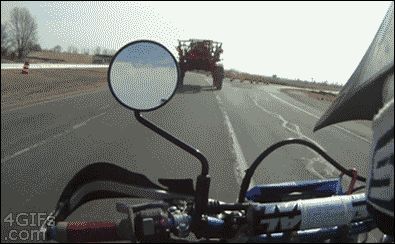 Motorcycle-passes-underneath-tractor.gif