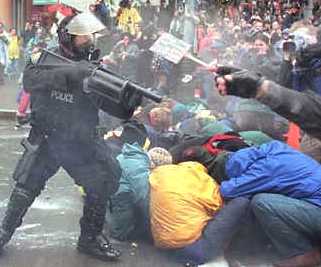 policeman_shooting_plastic_bullets_at_demonstrators_in_eattle.jpg
