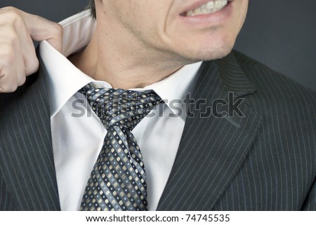 stock-photo-close-up-of-an-uncomfortable-businessman-pulling-at-his-collar-74745535.jpg